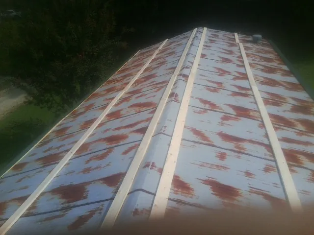 Rusted metal roof panels with new wood purlins before replacement — Storm Damage Roof Repair in Ramey by Roofing Brothers
